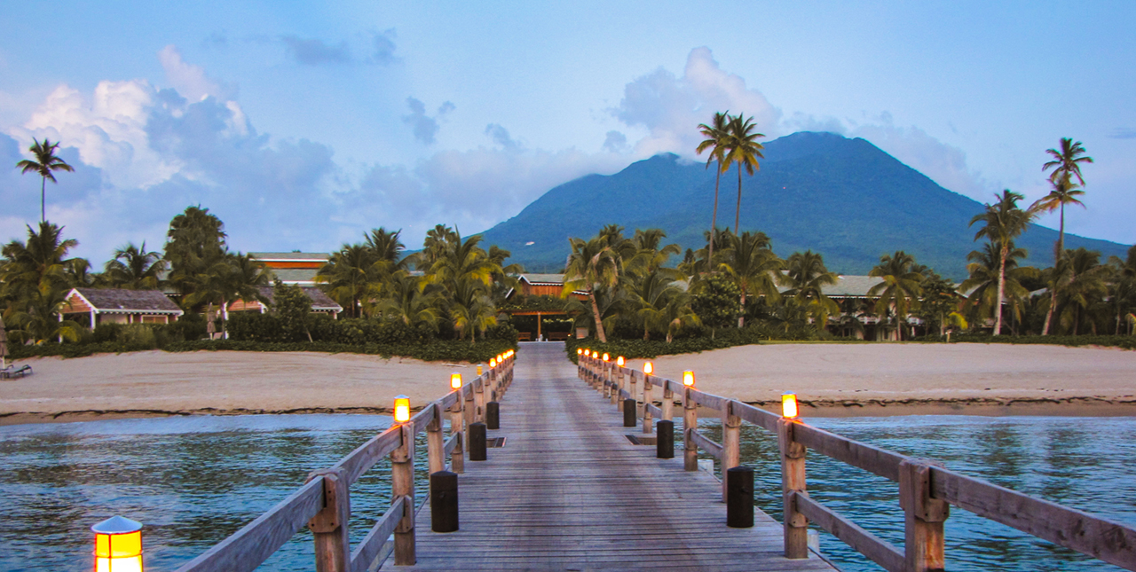 The image of Hotel Four Seasons from the bridge with the view onto Nevis Peak